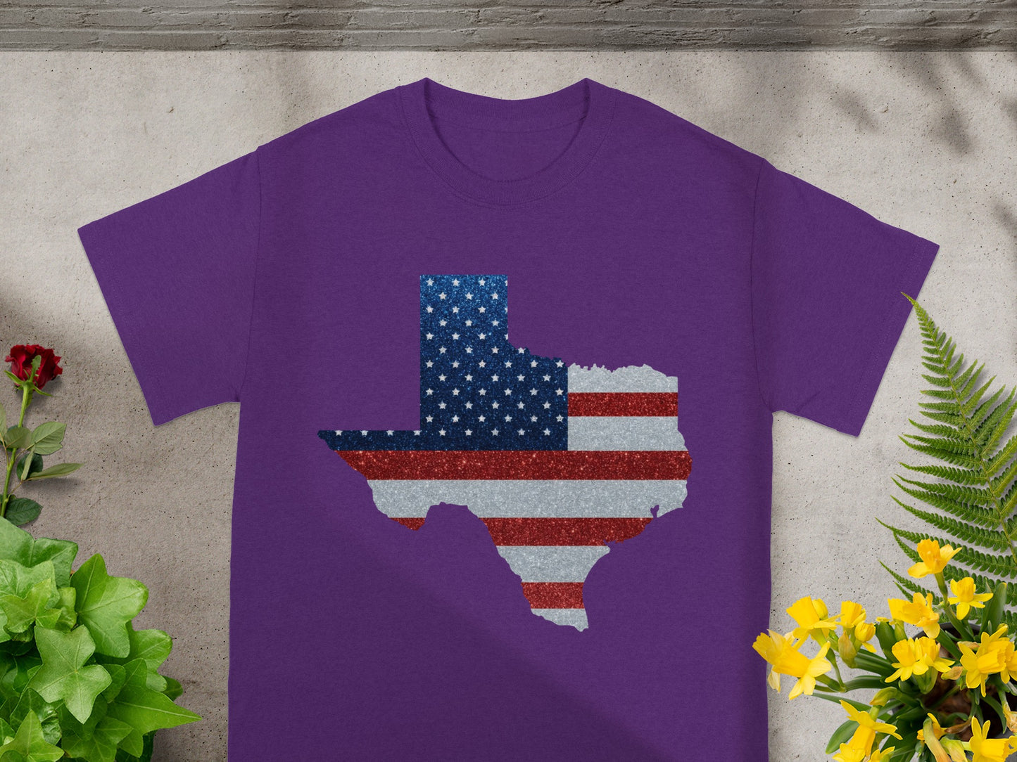 Purple t-shirt with Texas outline filled with American flag glitter design.