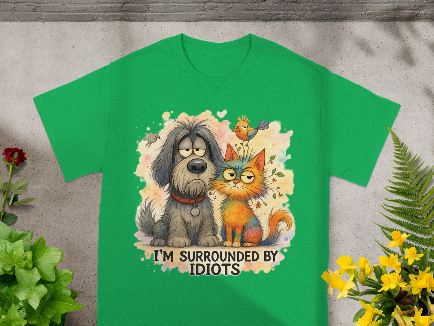 Green t-shirt with cartoon dog and cat, reads "I'm surrounded by idiots".