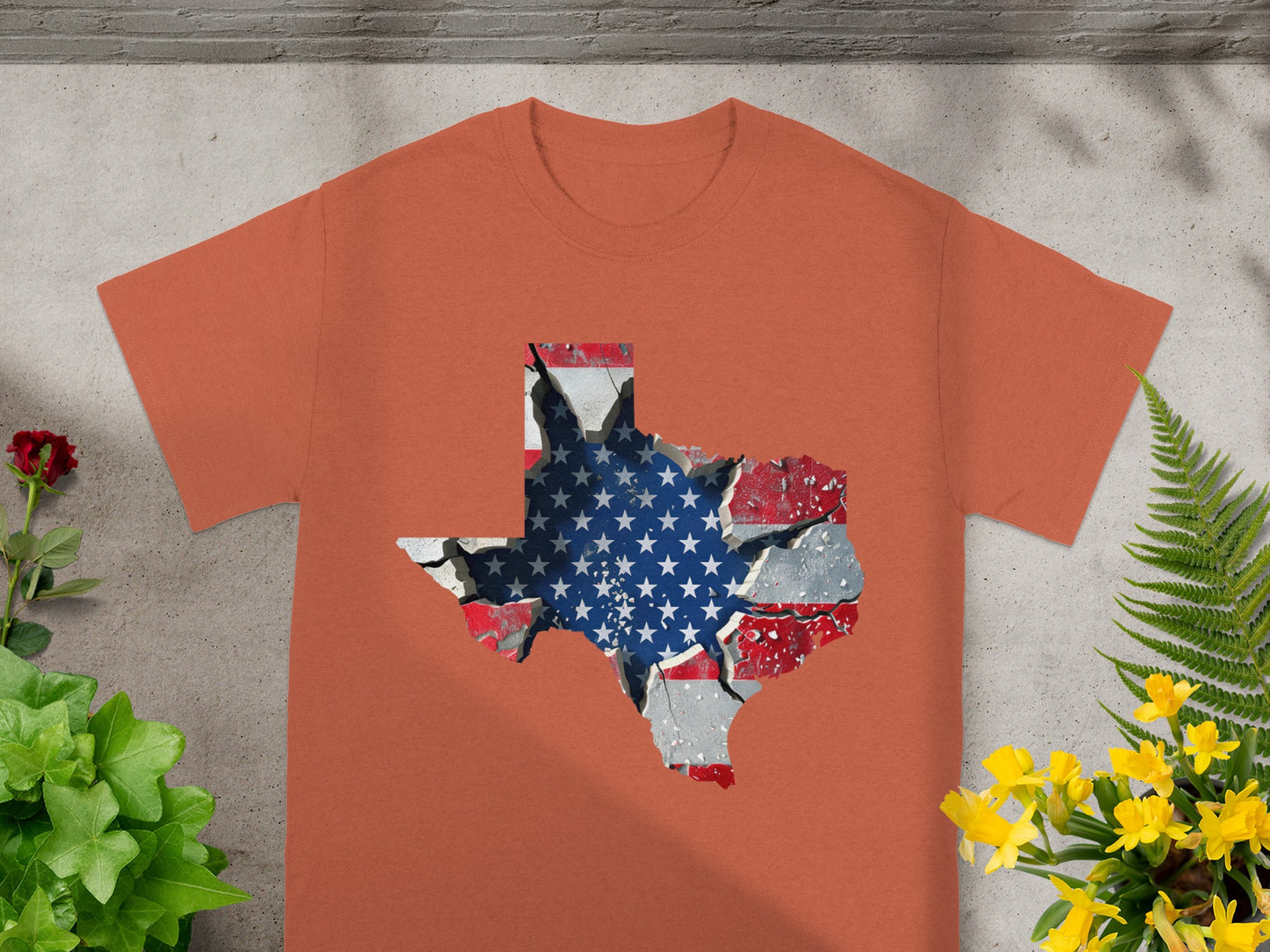 Orange t-shirt with a cracked Texas map graphic featuring the US flag.