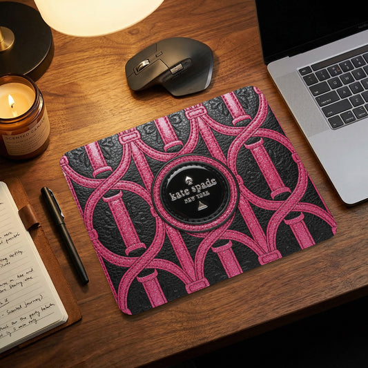 Kate Spade New York mousepad with pink and black chain link pattern.