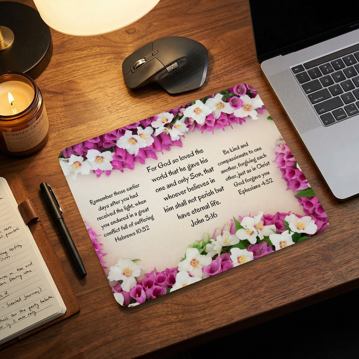 Mousepad featuring floral borders and Bible verses on a wooden desk with a laptop and candle.