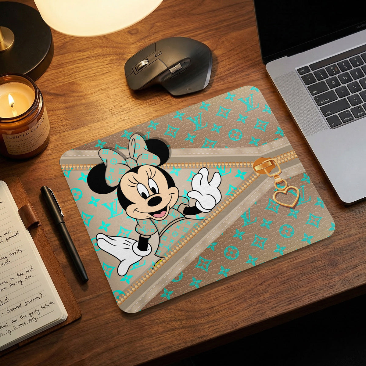Minnie Mouse on a brown mousepad with aqua monogram pattern and gold zipper detail.