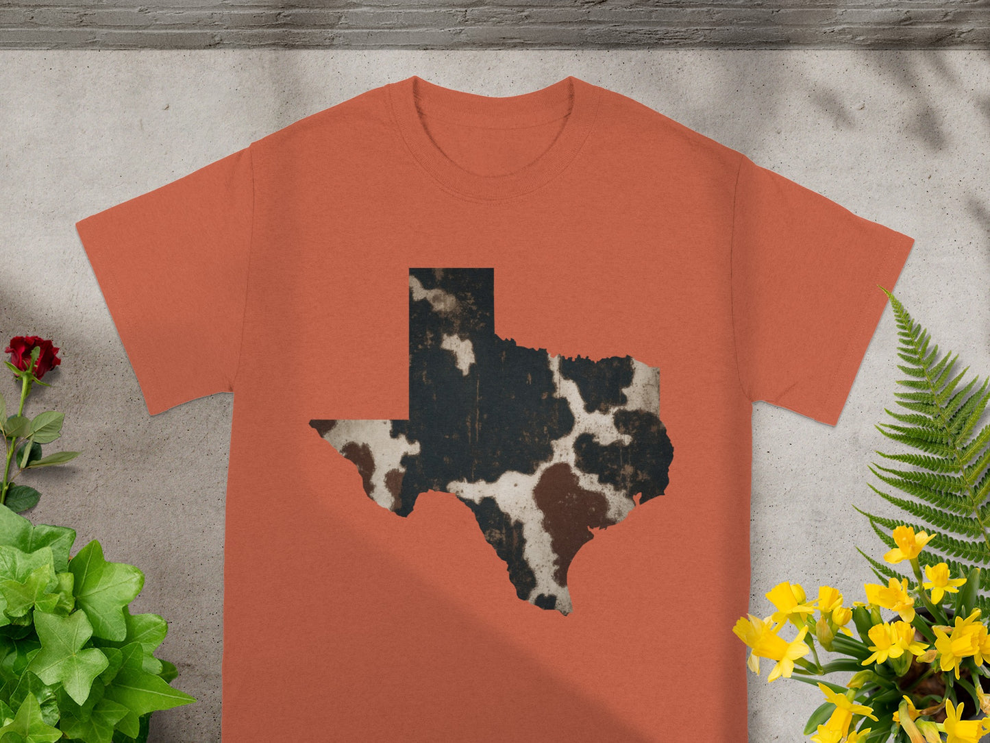 Orange t-shirt with a distressed Texas map overlay in cowhide print.