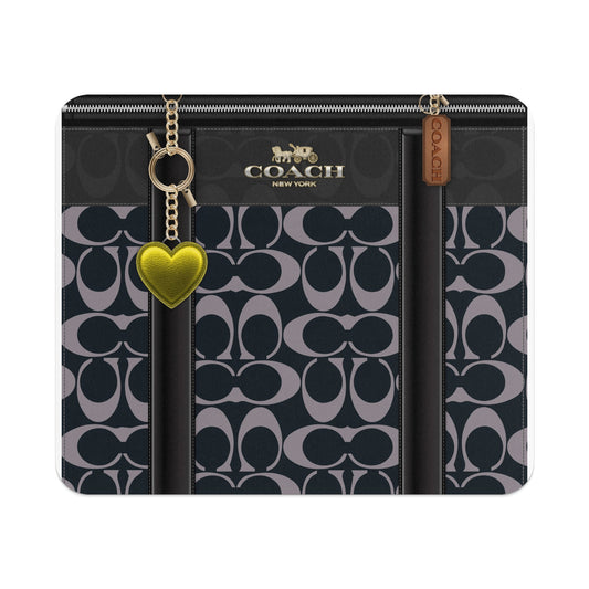 Coach signature pattern tote bag with gold heart charm and leather tag.