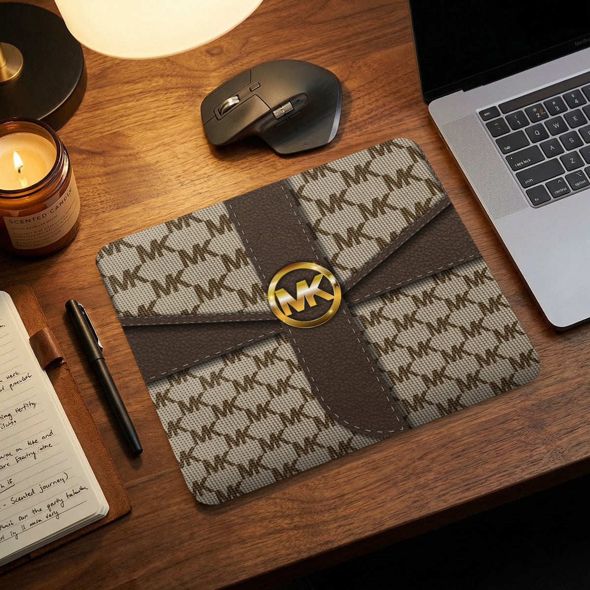 Michael Kors logo mousepad with MK pattern on a wooden desk.