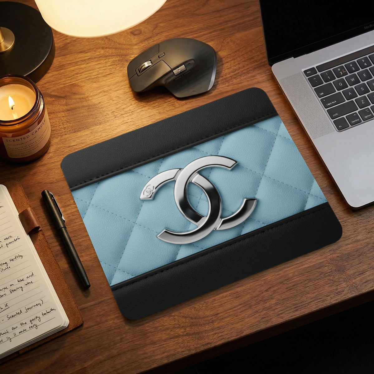 Quilted light blue and black mousepad with a silver double C logo.