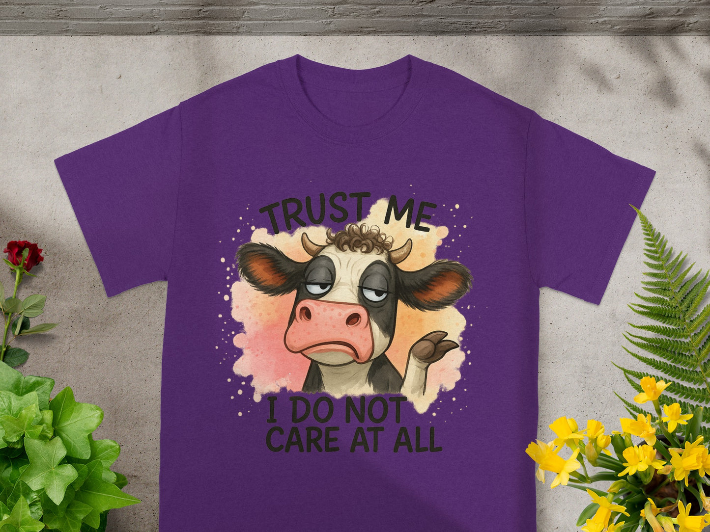 Purple t-shirt with cartoon cow saying "Trust me, I do not care at all."