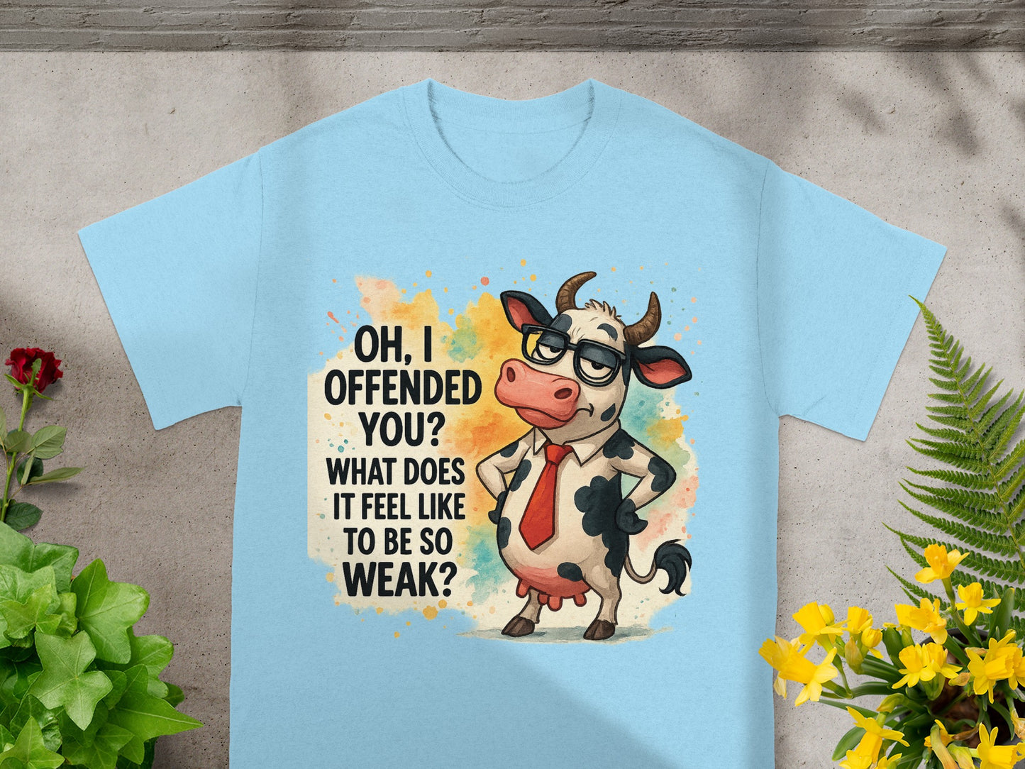 Light blue t-shirt with a cartoon cow in glasses and tie, text "OH, I OFFENDED YOU? WHAT DOES IT FEEL LIKE TO BE SO WEAK?".
