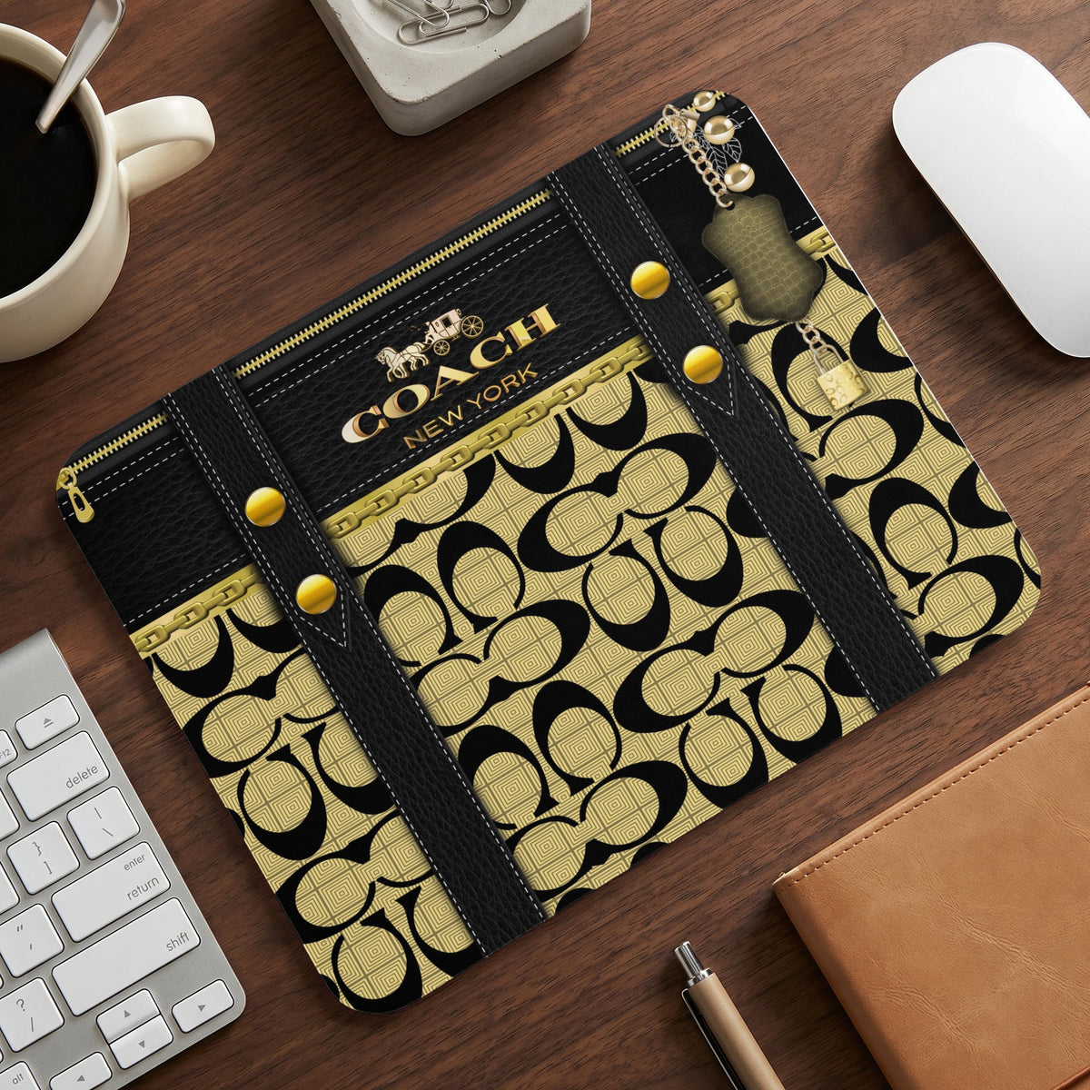Coach New York logo pattern mousepad with gold chain and padlock accents.