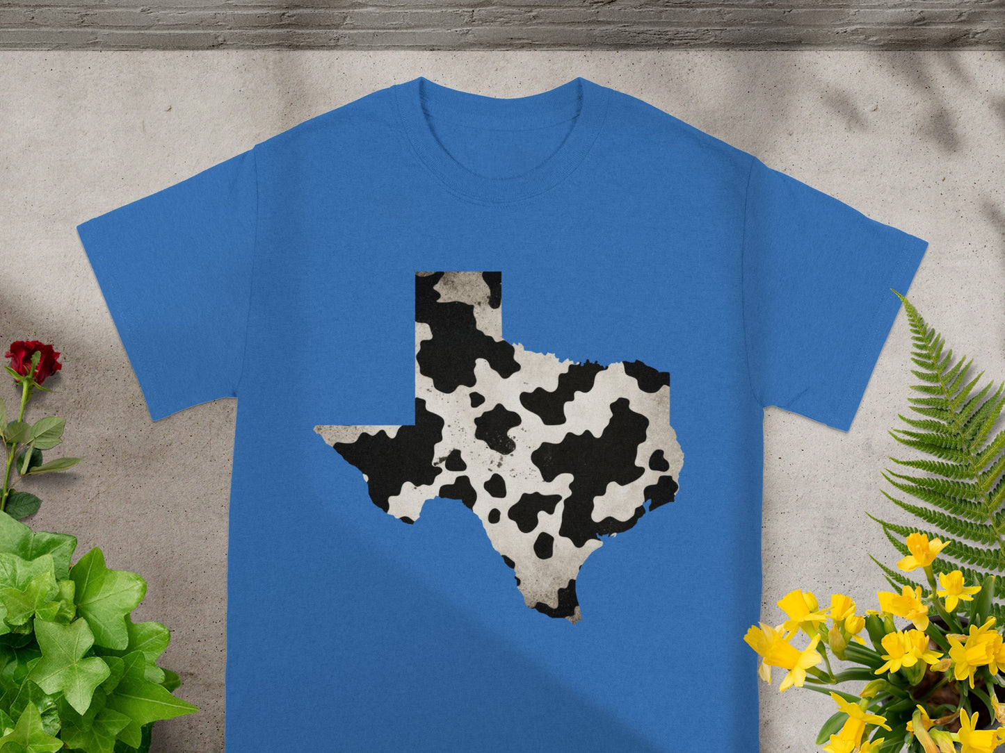 Blue t-shirt with Texas map outline in cow print pattern.