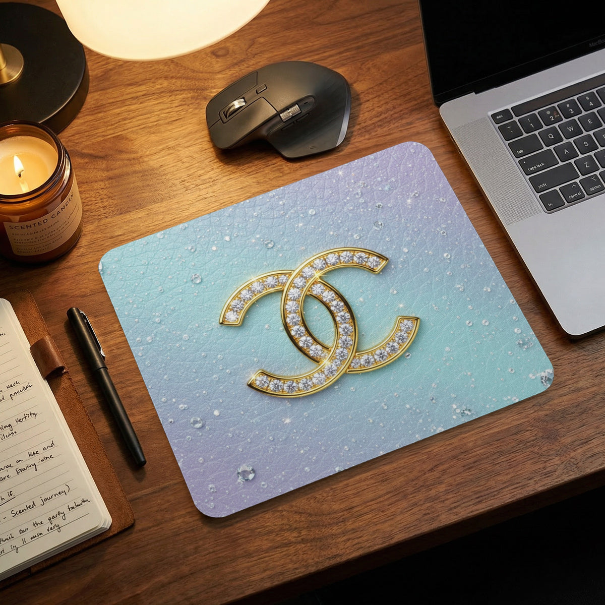 Mousepad with gold interlocking C logo on a gradient blue and purple background.