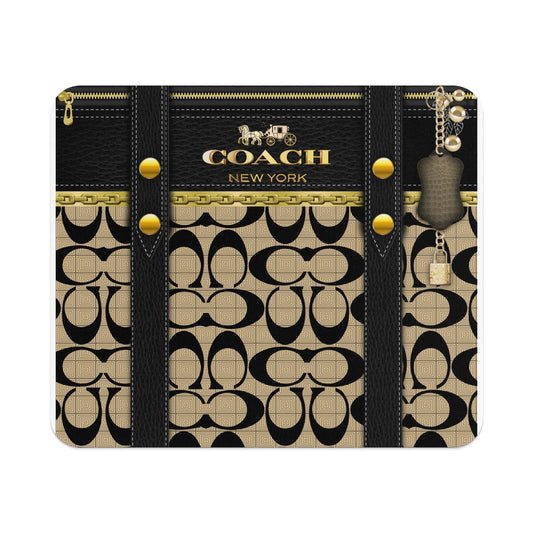 Coach New York pattern with gold chain and leather accents.
