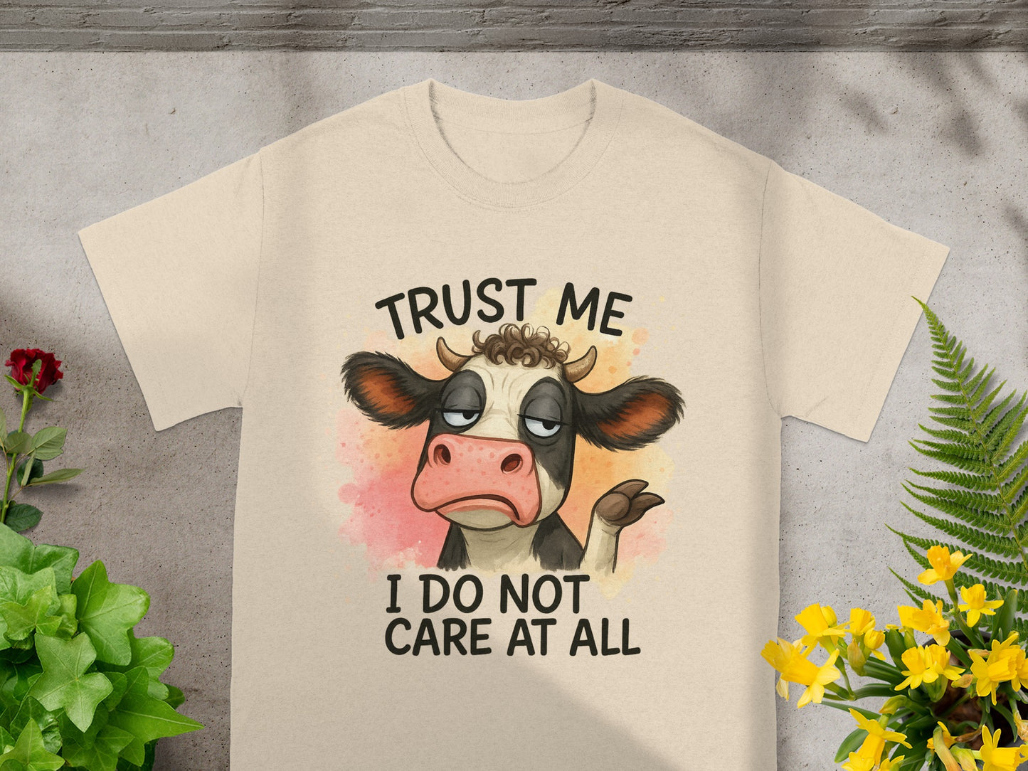 Cow with "Trust Me I Do Not Care At All" text on a cream t-shirt.