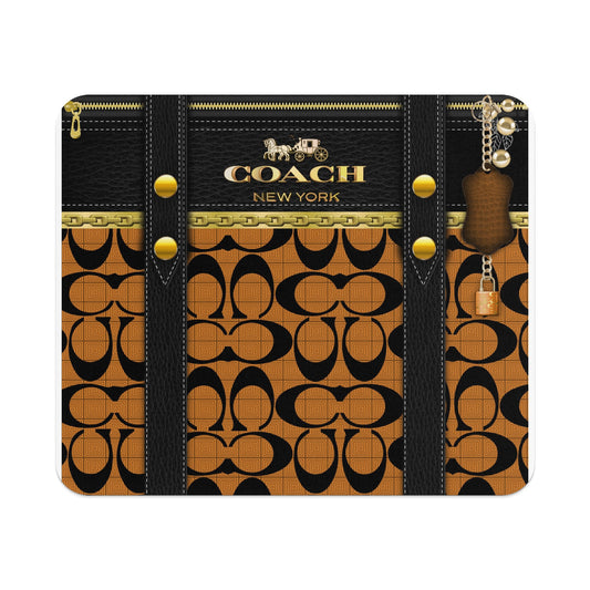 Coach pattern with black leather accents, gold zipper, and bag charm.