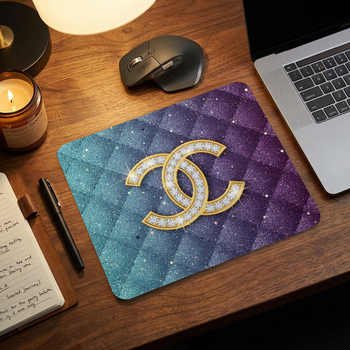 Mousepad with gold CC logo and diamond accents on glitter galaxy background.