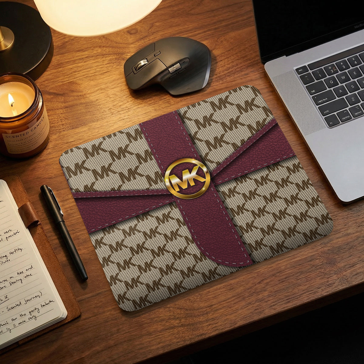 Michael Kors monogram mousepad with maroon ribbon and gold logo detail.