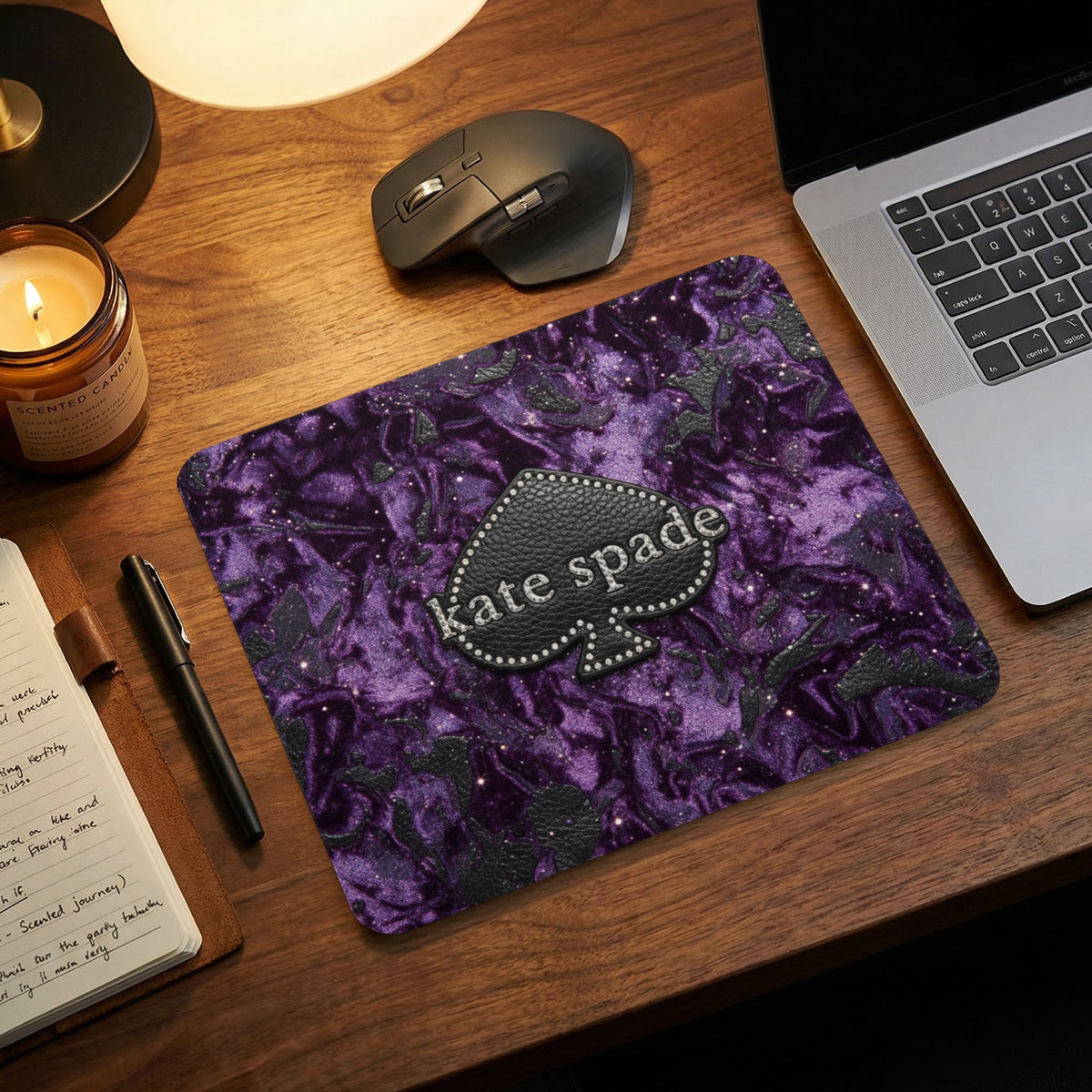 Kate Spade logo on purple textured mousepad with glitter accents.