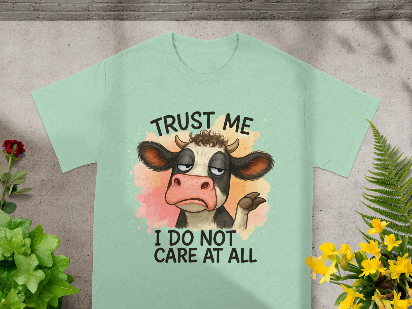 Light green t-shirt with a cow graphic that says "Trust Me I Do Not Care At All".