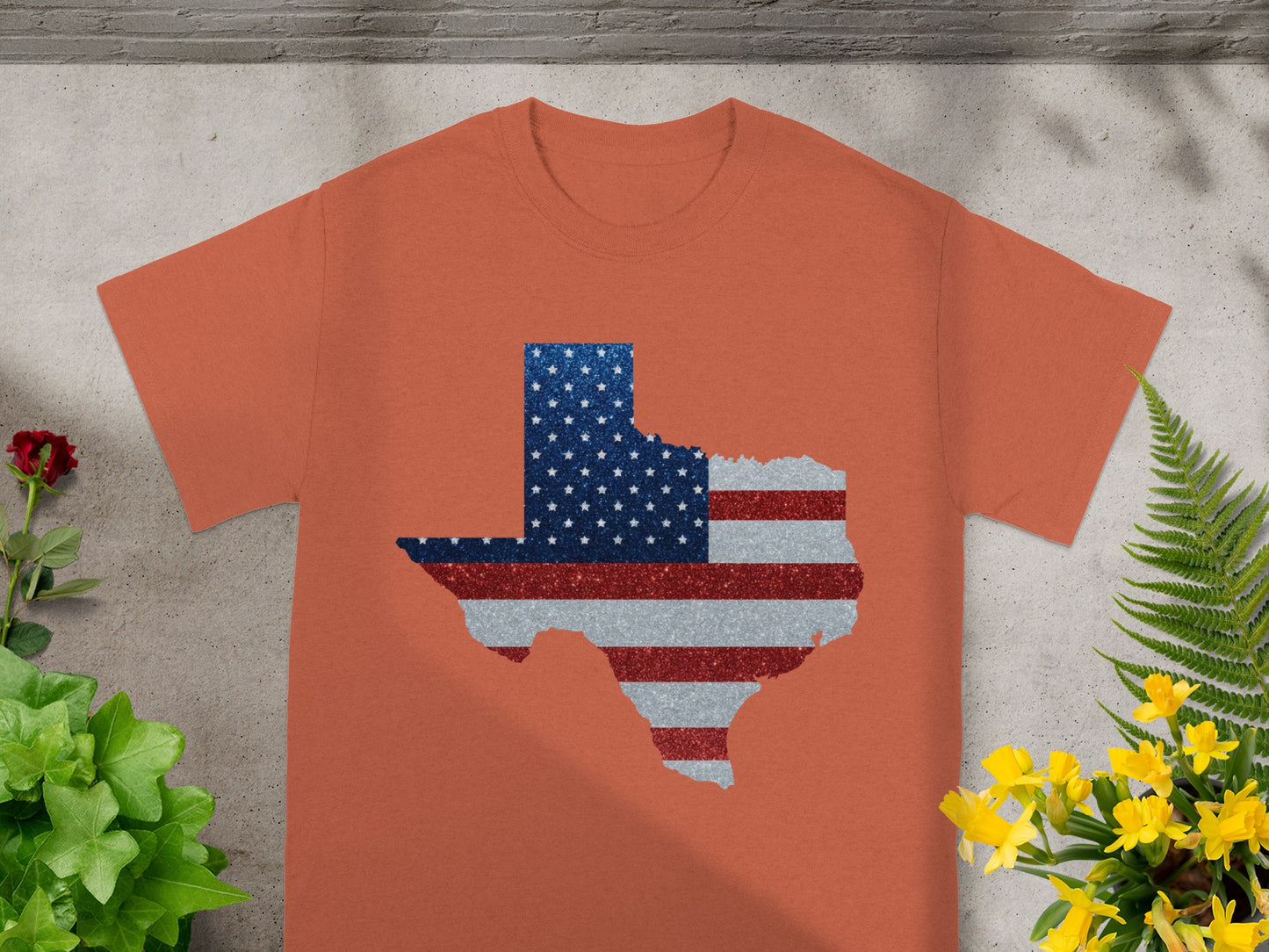 Orange t-shirt with a Texas map filled with a glittery American flag design.