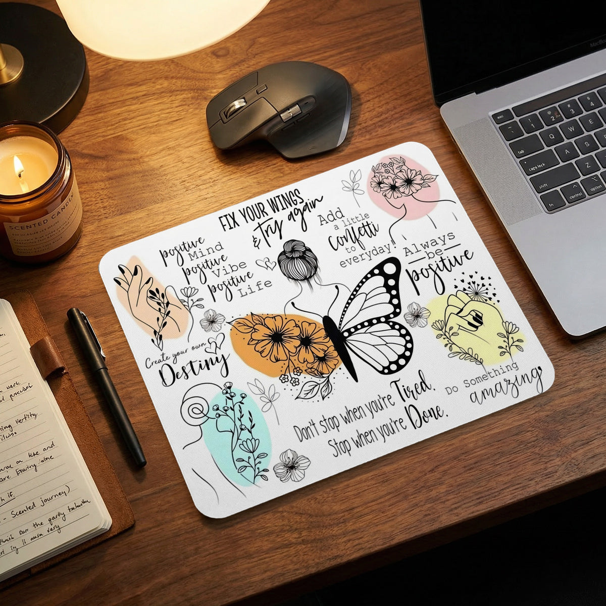 A white rectangular mouse pad featuring inspirational quotes, minimalist line art, and butterfly graphics on a wooden desk.