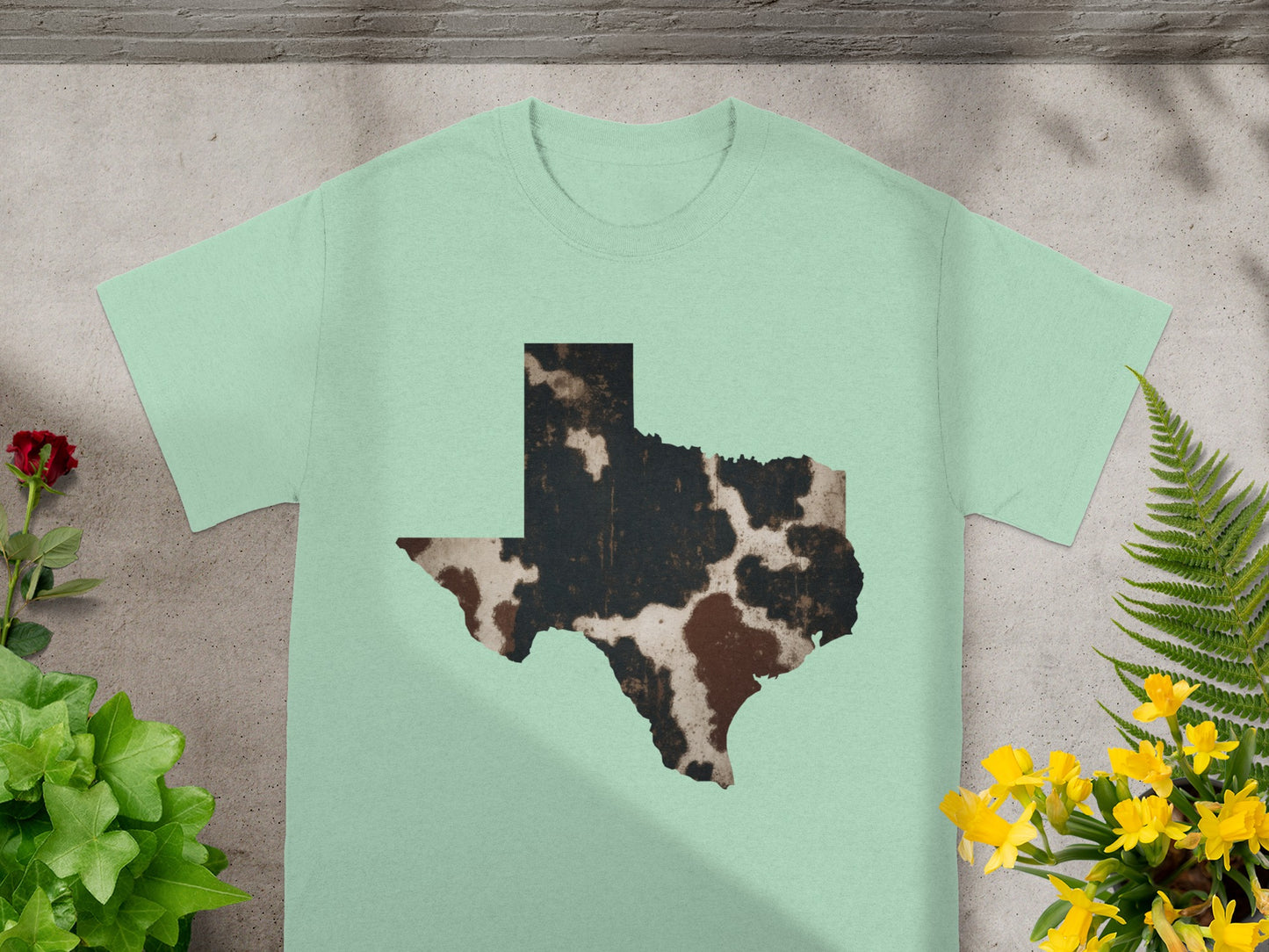 Texas outline t-shirt with cow print design and floral accents