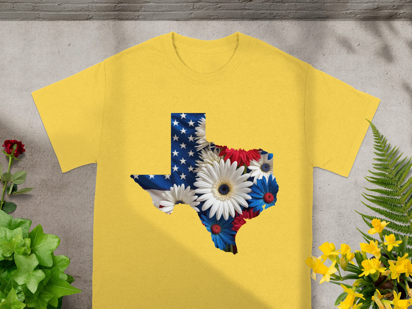 Yellow t-shirt with Texas outline filled with US flag and flowers.