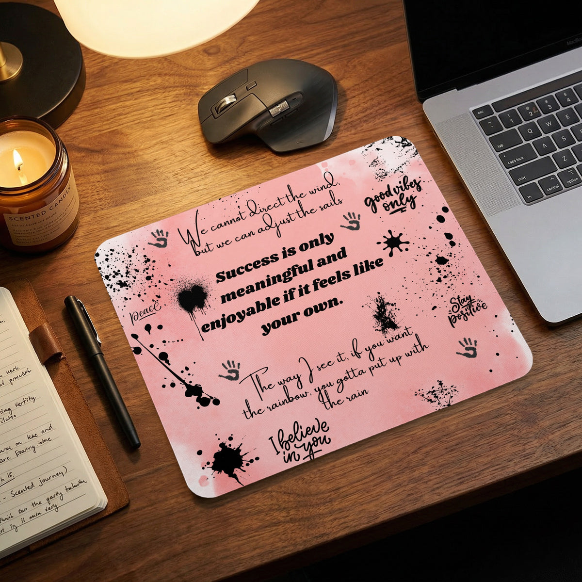 Pink mousepad with black splatters and inspirational quotes like "good vibes only" and "I believe in you".
