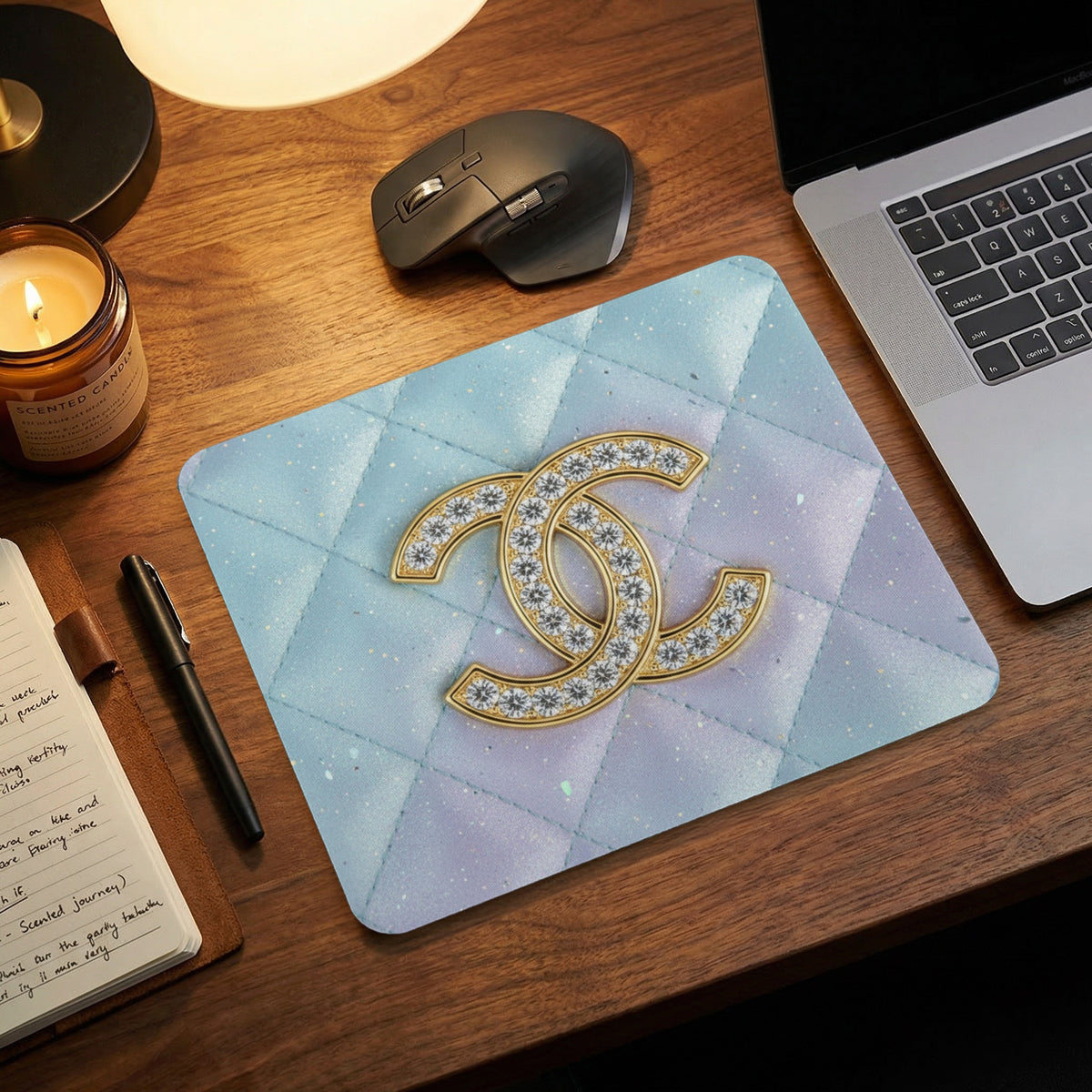 Quilted mousepad with gold double 'C' logo and diamond accents.
