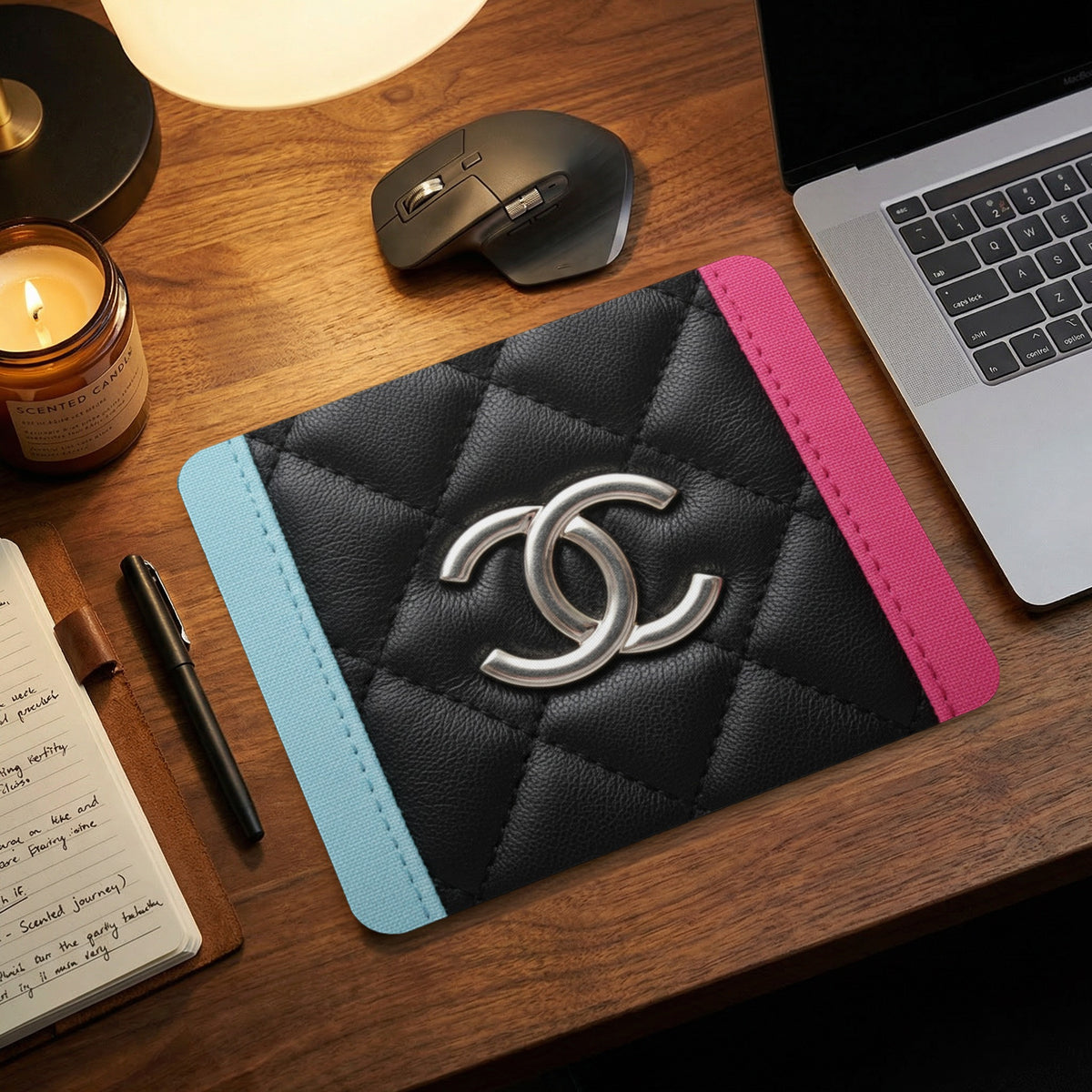 Quilted black mousepad with silver CC logo, light blue and pink trim.