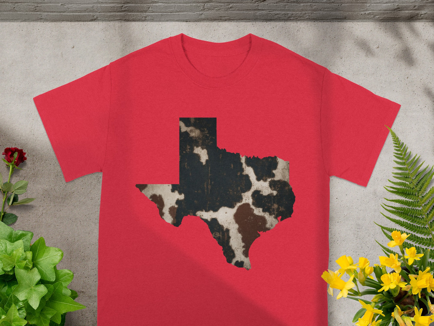 Red t-shirt with a distressed cowhide pattern shaped like the state of Texas.