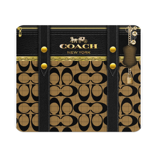 Coach logo on black leather with gold chain accents and patterned background.