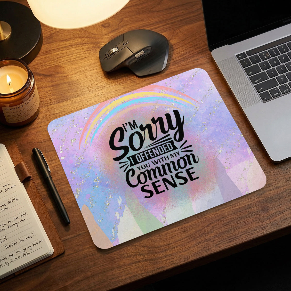 A rectangular mouse pad with pastel watercolor background and text reading I'm sorry I offended you with my common sense.