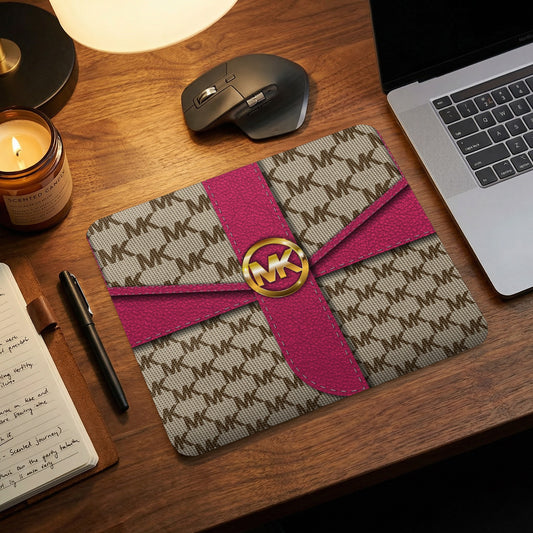 Michael Kors print laptop sleeve with pink ribbon and gold logo.