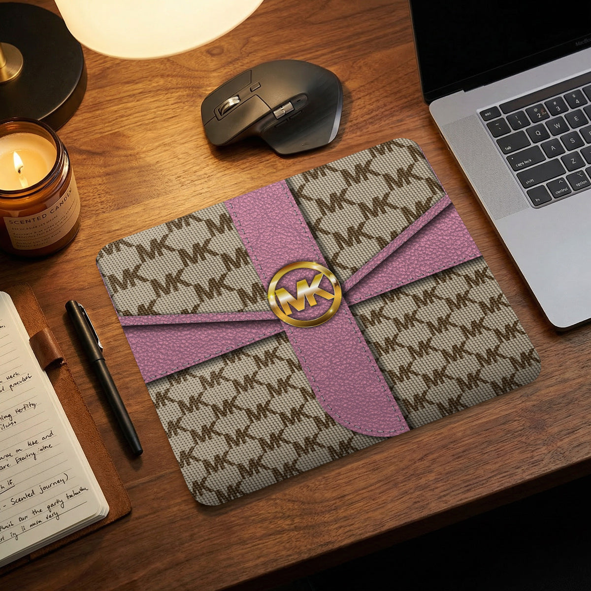 Michael Kors patterned mousepad with pink ribbon accent and gold logo.