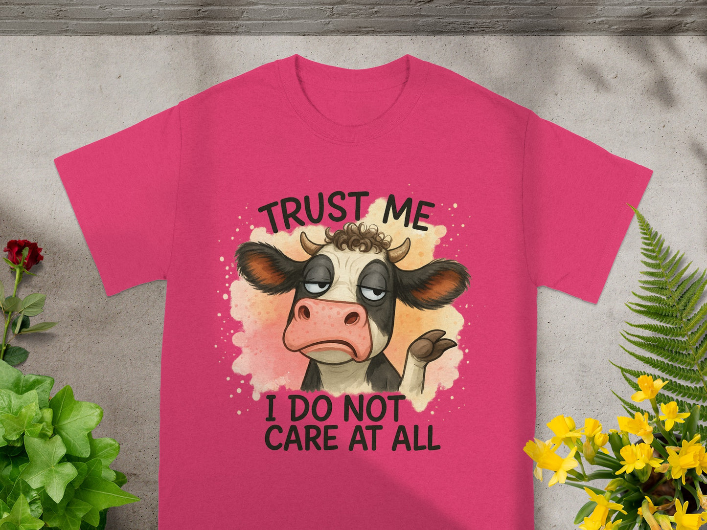 Pink t-shirt with cartoon cow saying "Trust me, I do not care at all."