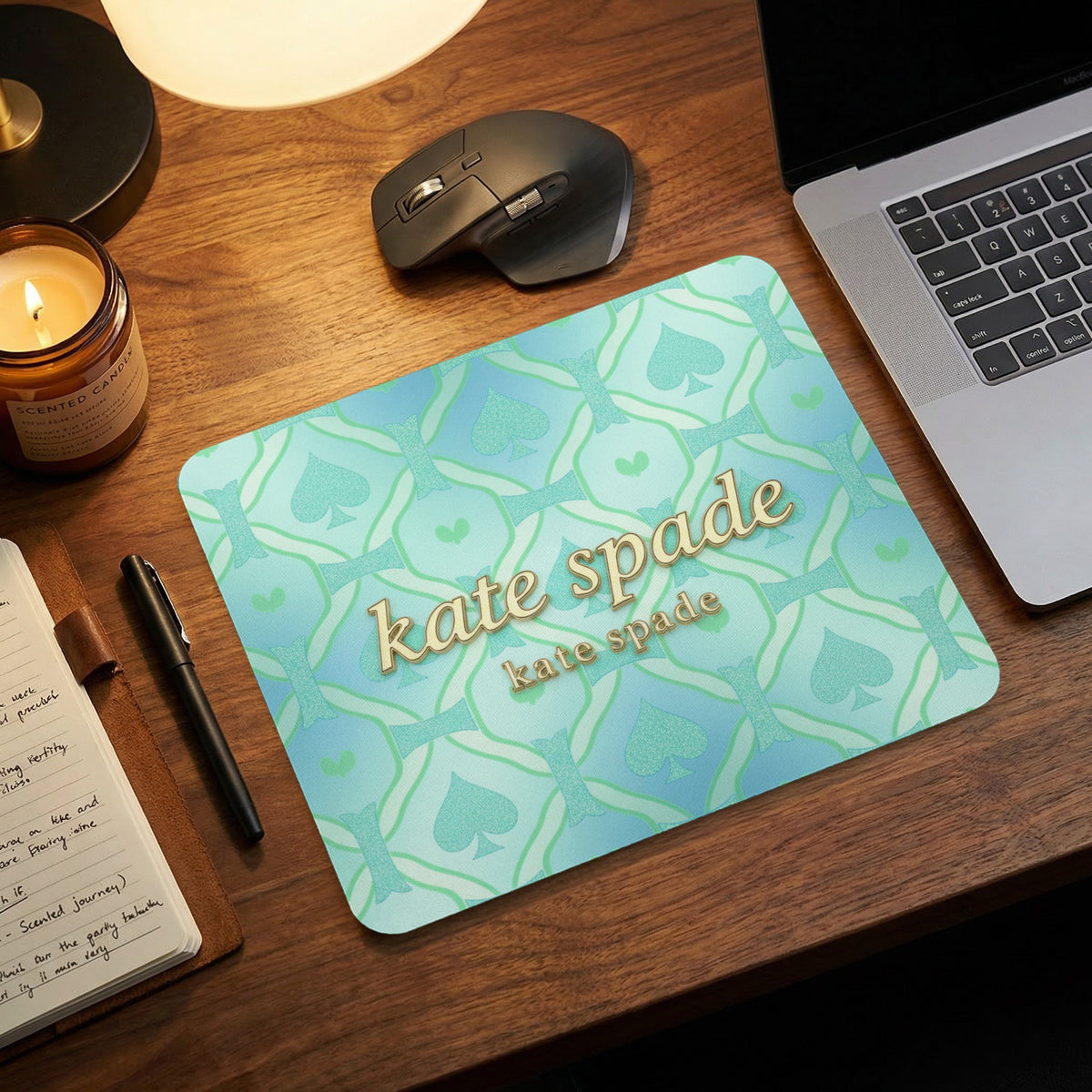 Kate Spade mousepad with repeating spade pattern and gold logos.
