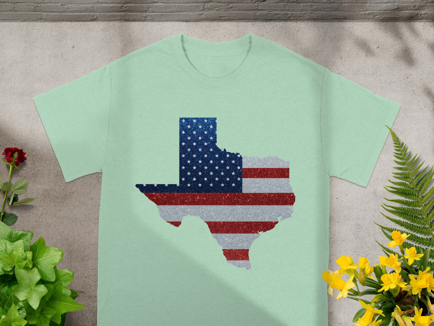 Light green t-shirt with Texas outline in American flag glitter design.