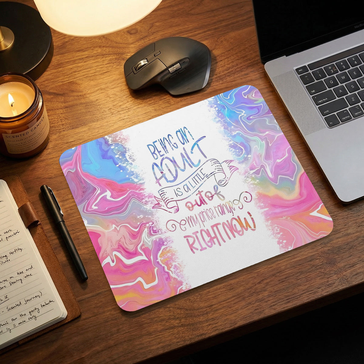 Mousepad with marbled pink, blue, and purple design and text "Being an adult is a little out of my price range right now."