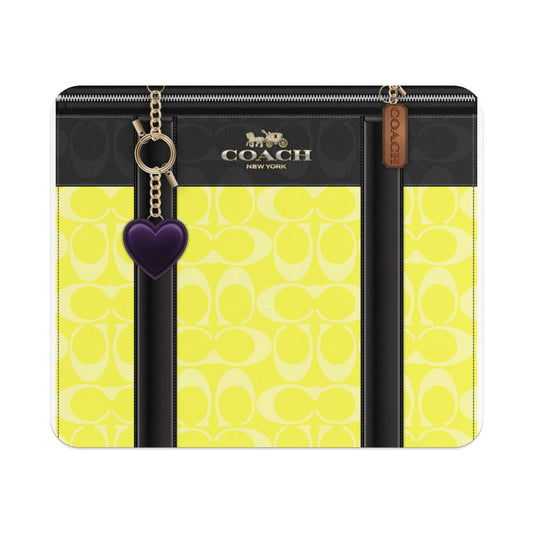 Coach wallet with yellow signature "C" pattern and purple heart charm.