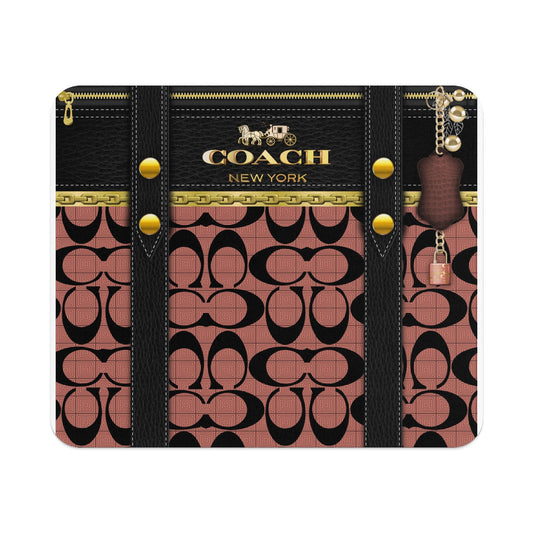 Coach print wallet with gold chain trim and leather strap with padlock charm.