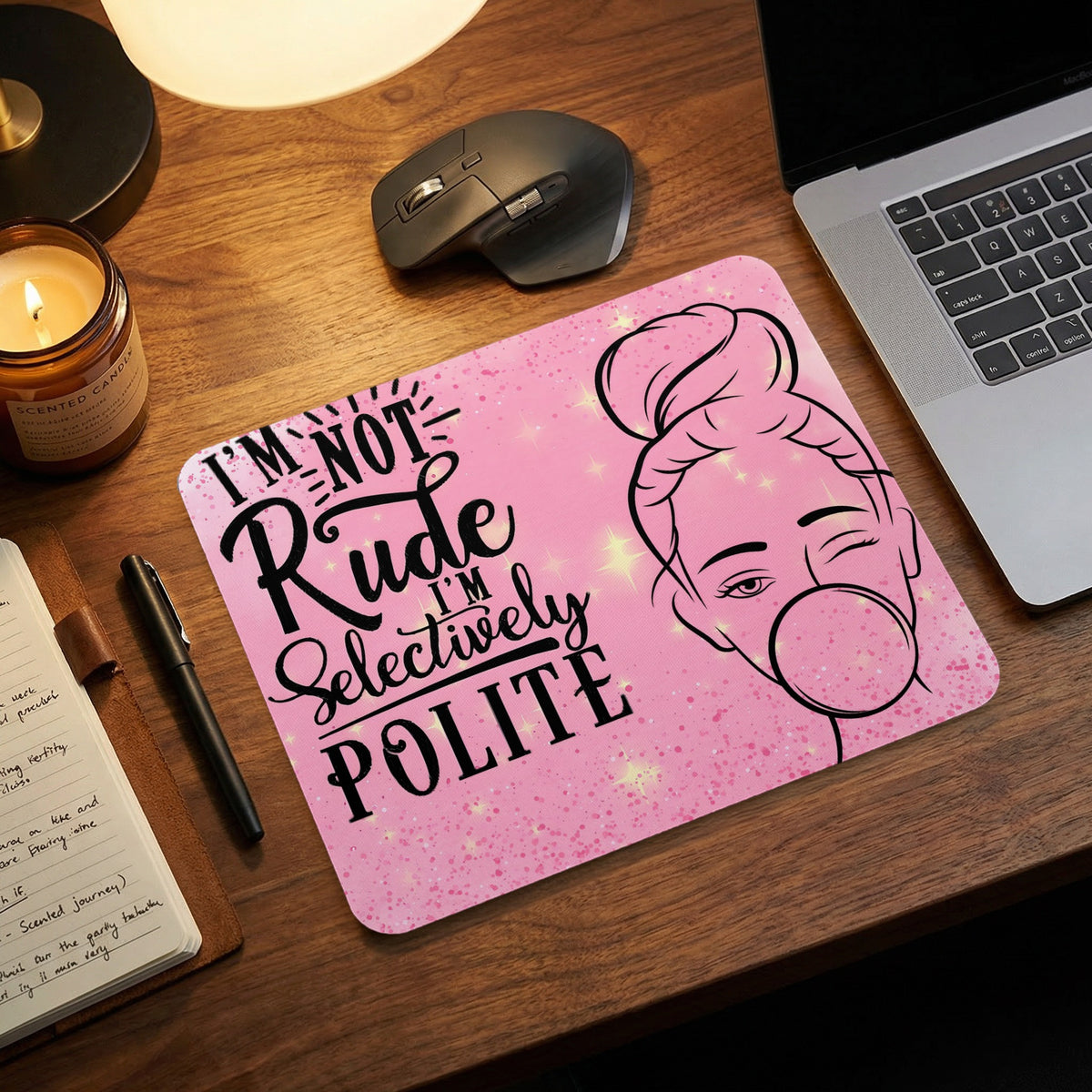 Pink rectangular mouse pad featuring the text I'm not rude, I'm selectively polite and a woman blowing a bubble.