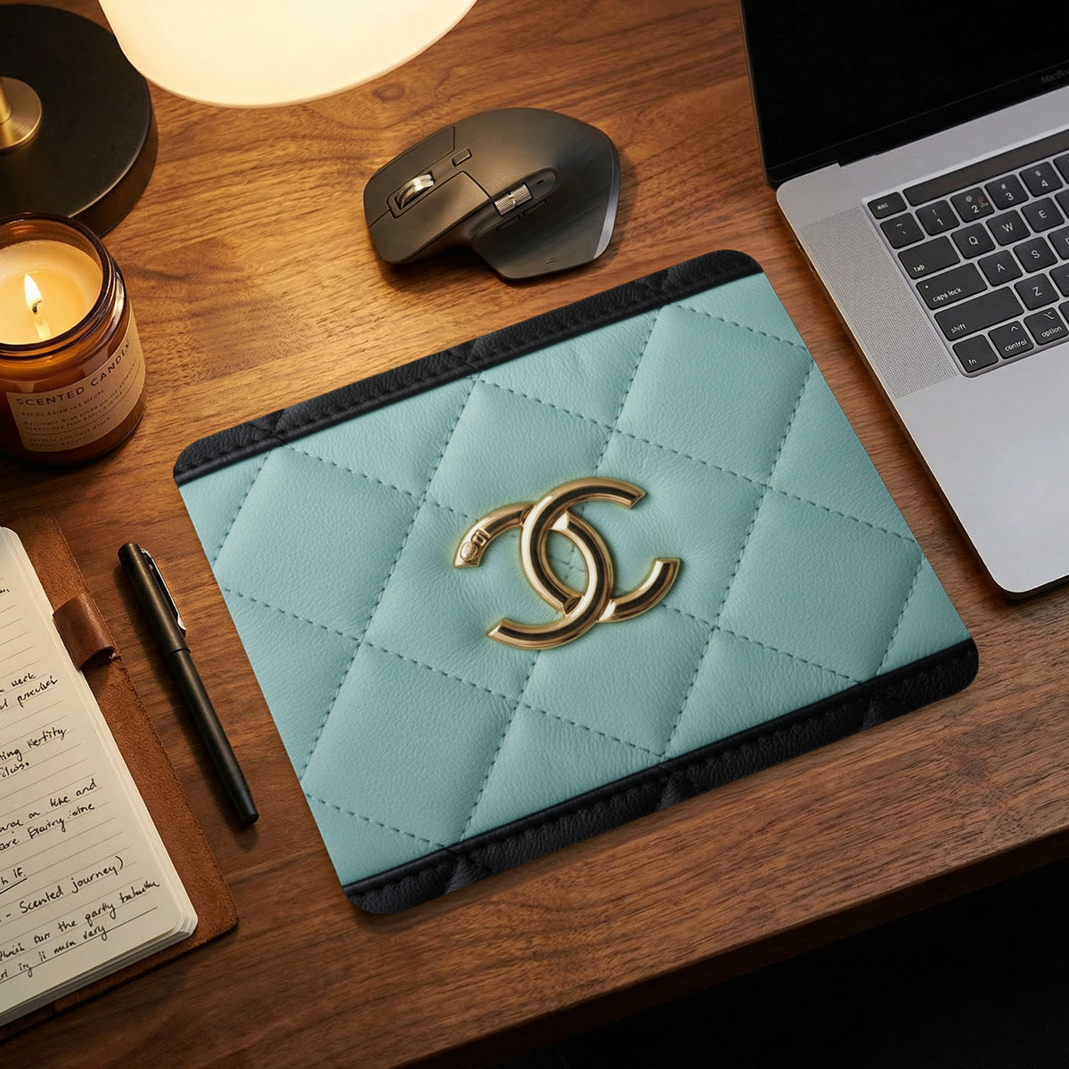 Light blue quilted mat with gold logo on a wooden desk.