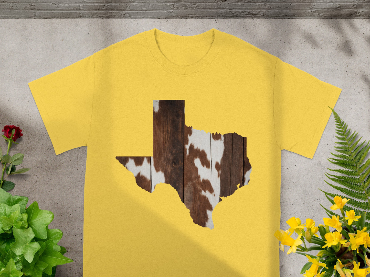 Yellow t-shirt with Texas shape filled with wood and cowhide pattern.