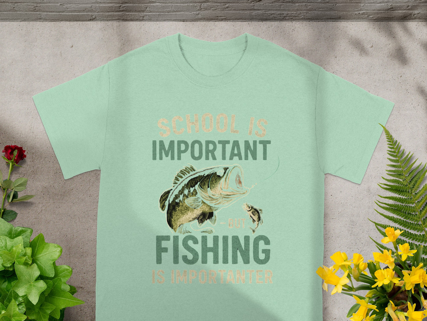 Mint t-shirt with "School is important but fishing is importanter" text and fishing graphic.