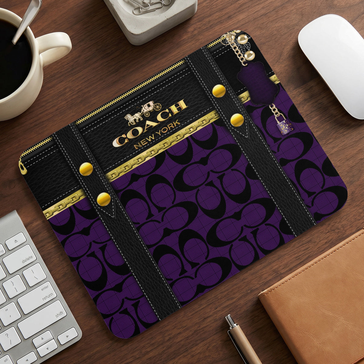 Coach New York mousepad with purple signature pattern and gold accents.