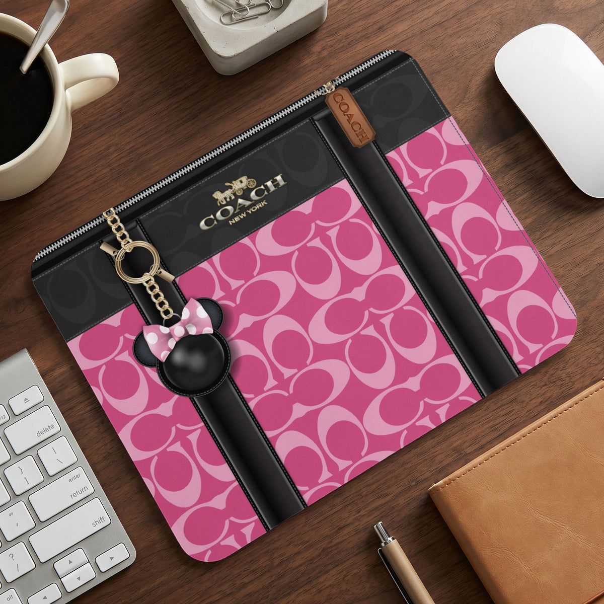 Coach patterned mousepad with Mickey Mouse ear charm and gold chain.